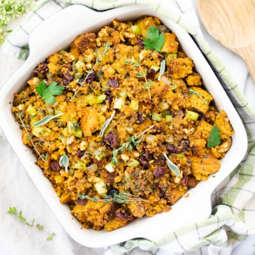 corn bread stuffing in pan with fresh herbs