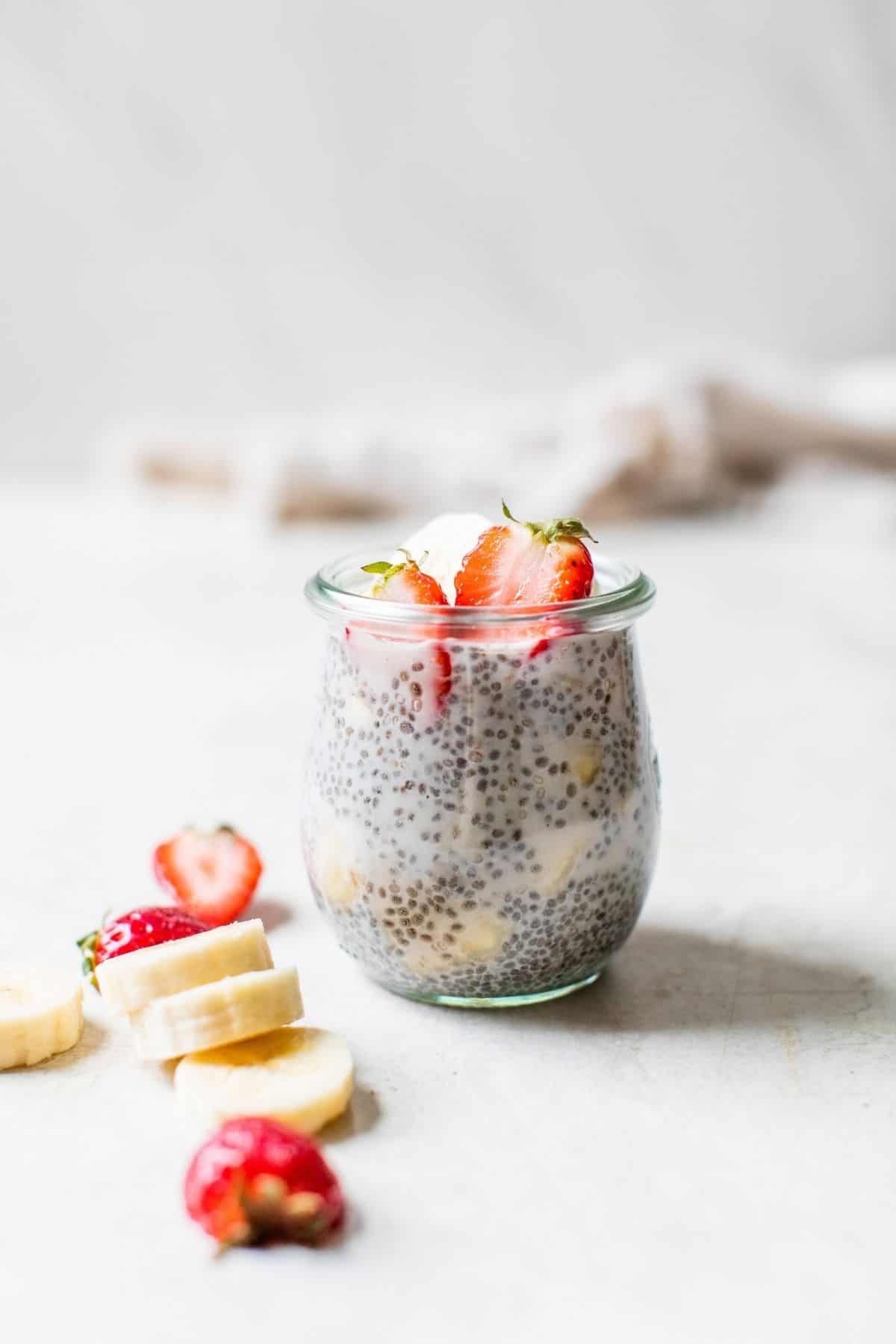 strawberry banana chia seed pudding in a glass jar