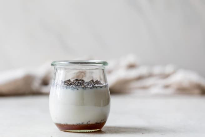 combining chia seeds with milk in a glass jar