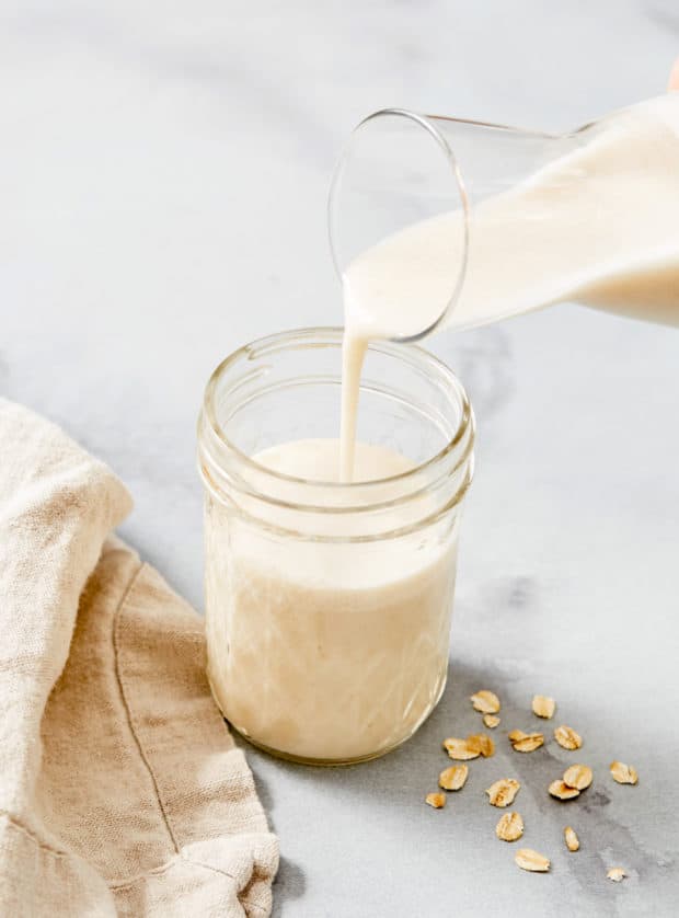 oat milk pouring into cup