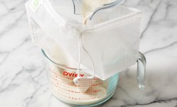 milk pouring into nut bag