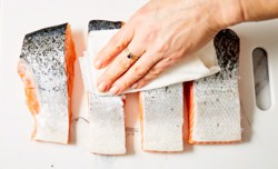 patting salmon with paper towel