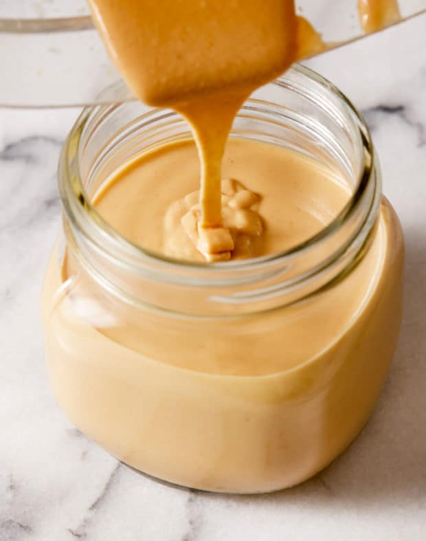 peanut butter pouring into jar