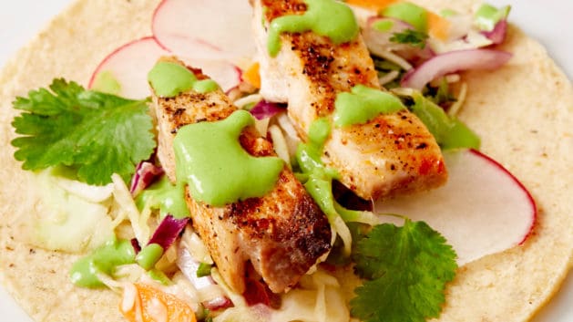 open-faced fish taco on white plate