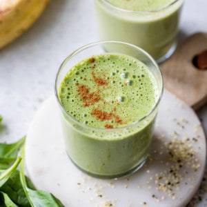 green breakfast smoothie topped with cinnamon