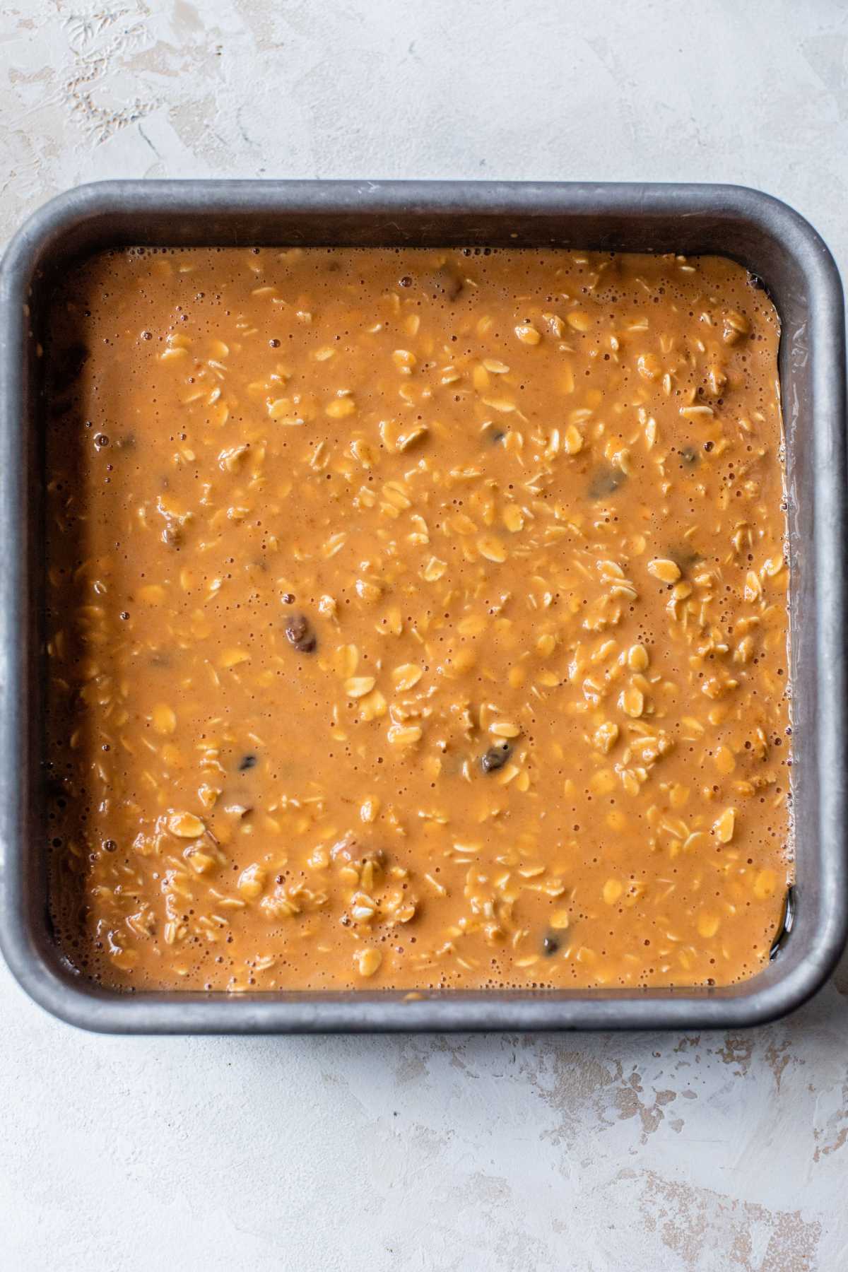 Oat and pumpkin mixture in a baking pan.
