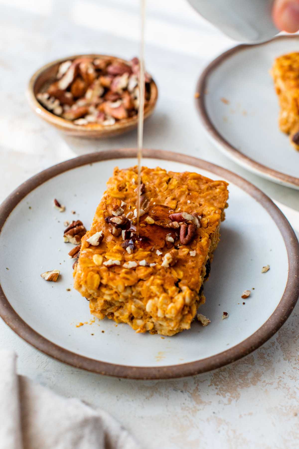 Drizzling syrup on a serving of baked pumpkin oatmeal.