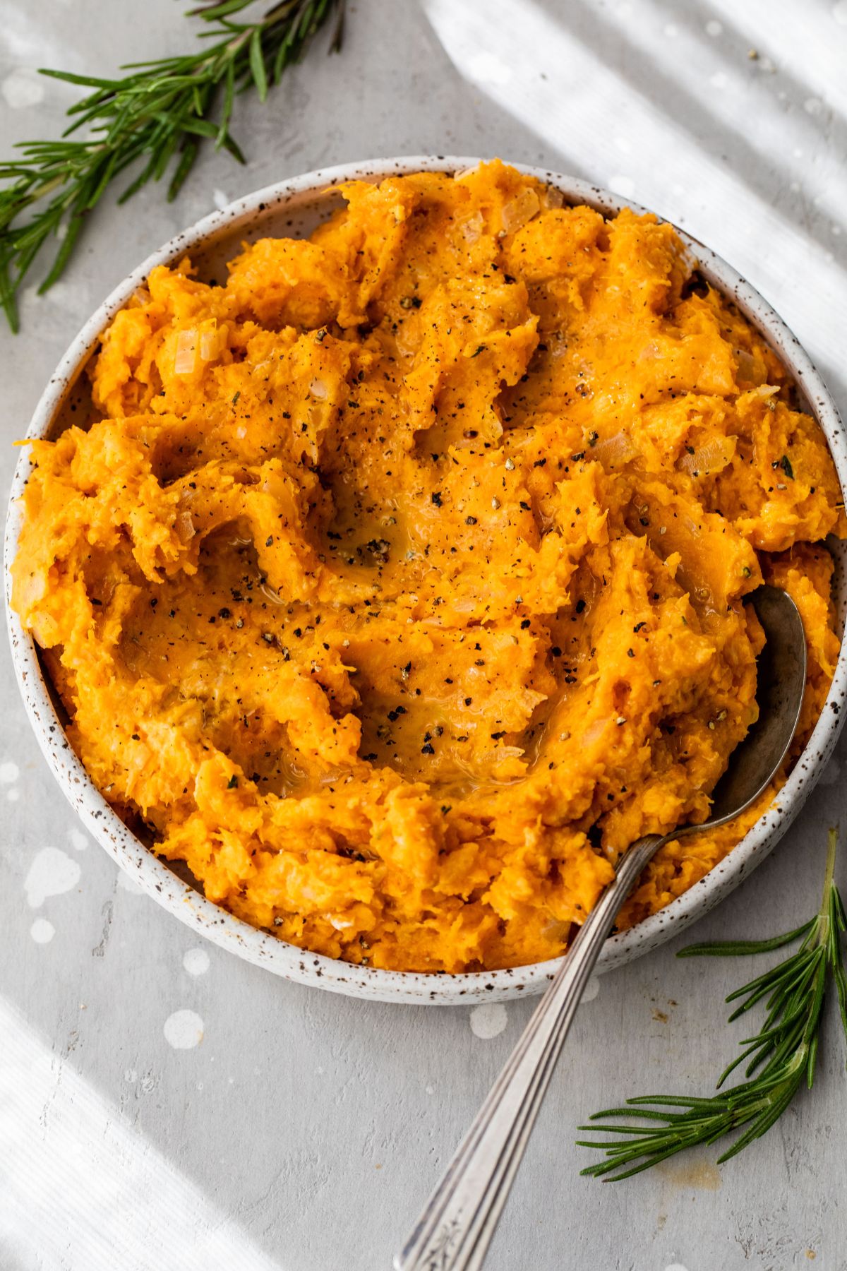 Mashed sweet potatoes in a large serving bowl.
