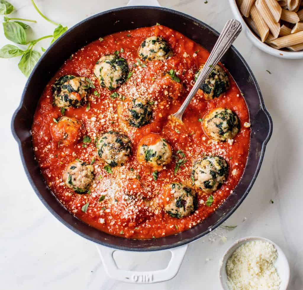 turkey spinach meatballs in skillet with tomato sauce