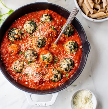 turkey spinach meatballs in skillet with tomato sauce