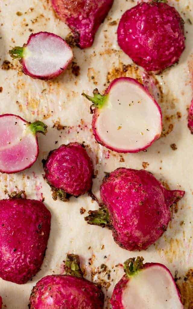radishes cooked on a parchment lined baking sheet