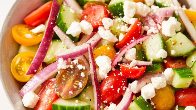 tomato cucumber and onion salad tossed in a vinaigrette