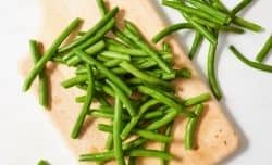 trimmed green beans on a cutting board
