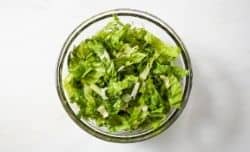 romaine lettuce with herbs in a large bowl