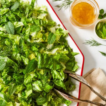 romaine lettuce salad with dressing and fresh herbs