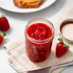 strawberry chia jam in a mason jar with peanut butter toast