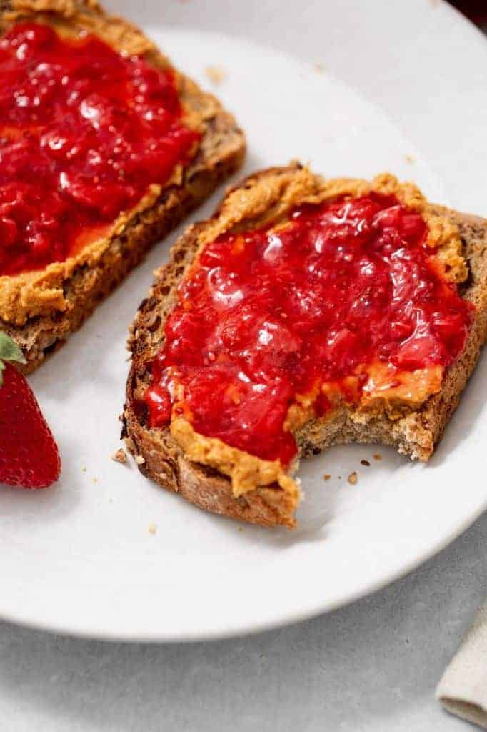 strawberry chia jam on a slice of toast with a bite taken out