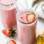 strawberry banana smoothies with a glass straw
