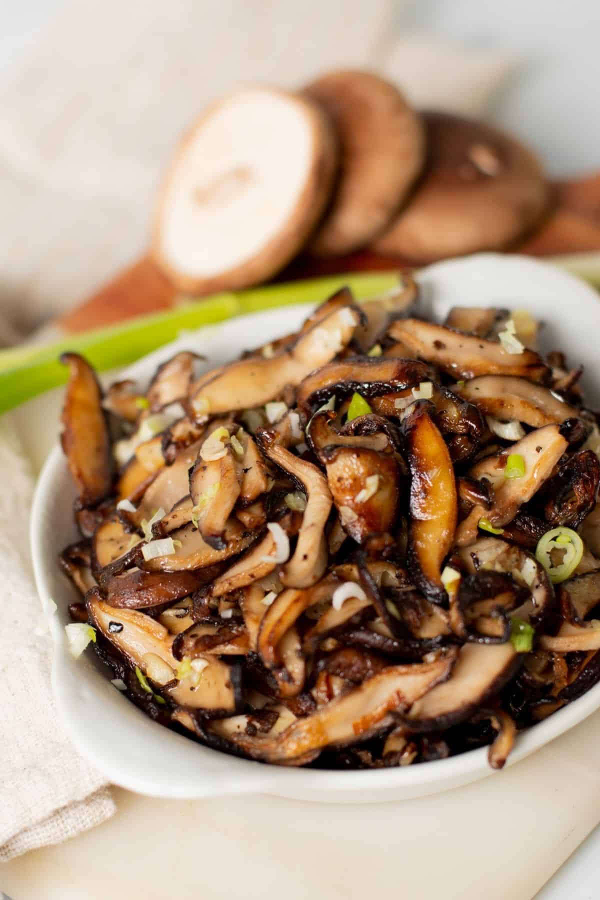 sautéed shiitake mushrooms in a small white bowl