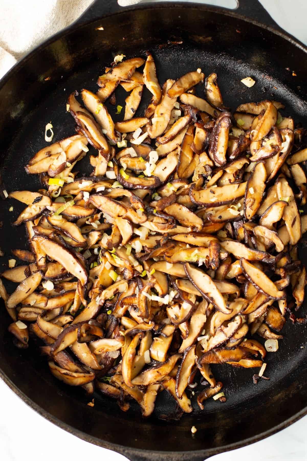 shiitake mushrooms recipe cooking in a cast iron skillet