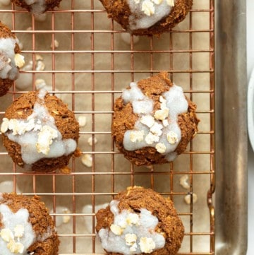 pumpkin oatmeal cookies topped with glaze and rolled oats