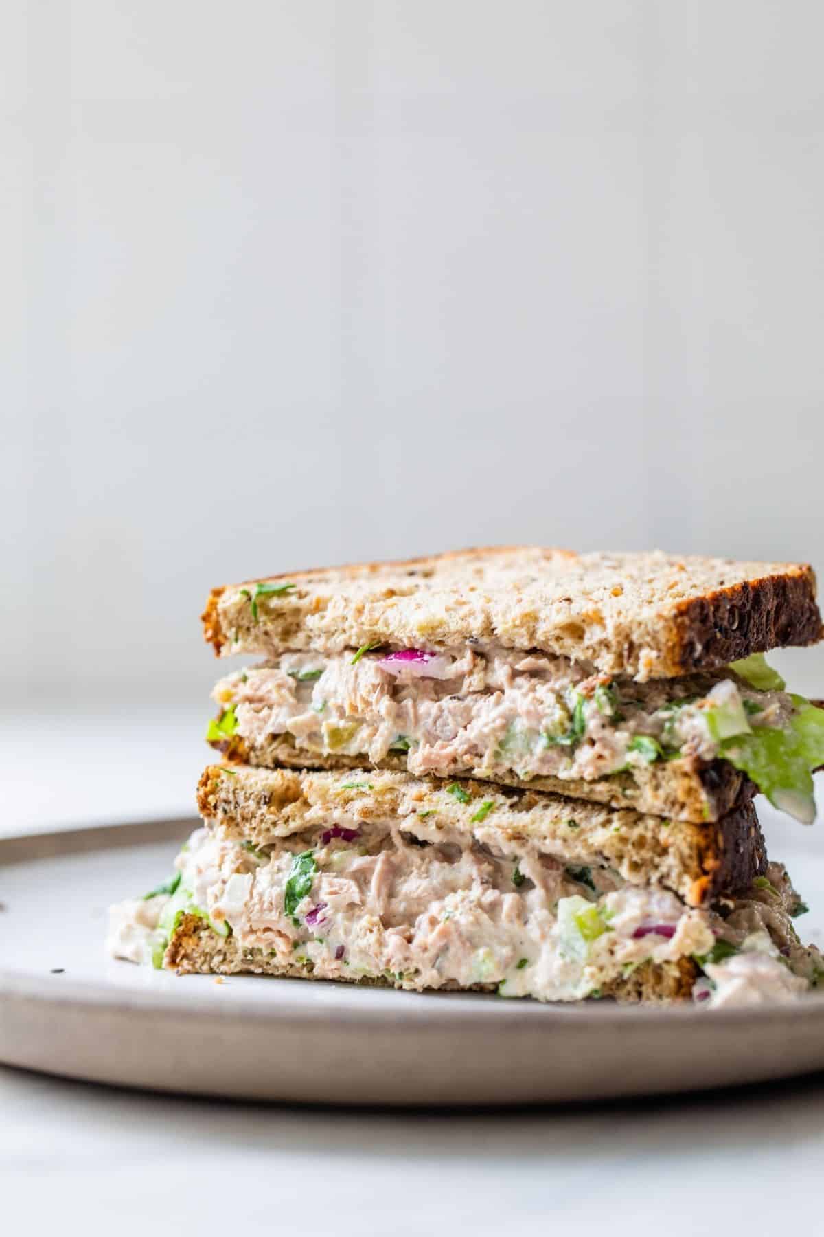 tuna salad sandwich served on a small white plate