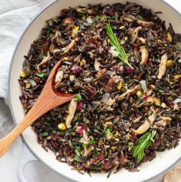 wild rice stuffing in a large white serving bowl