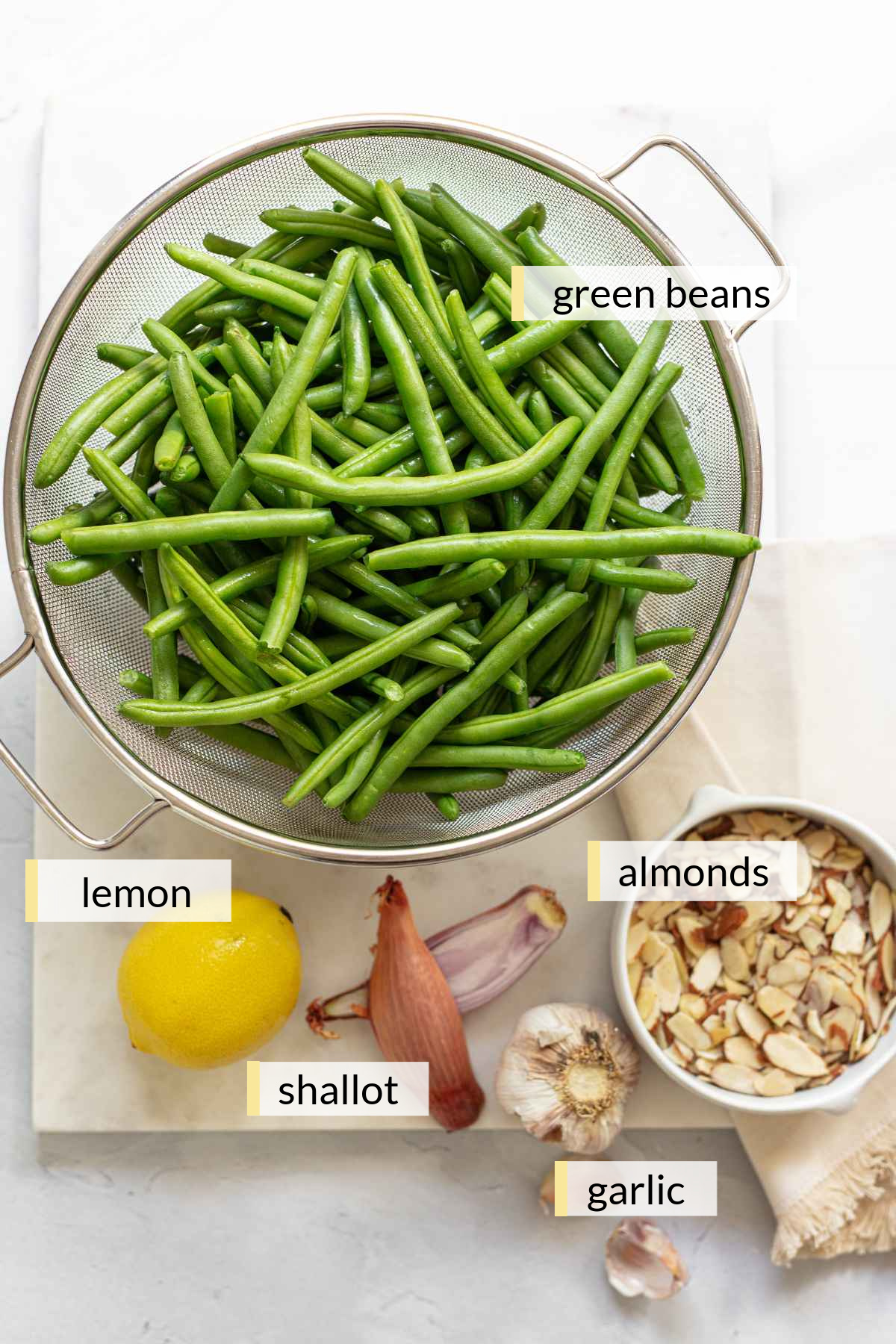 Fresh green beans, lemon, garlic cloves, shallot and sliced almonds.