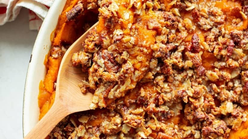 healthy sweet potato casserole with a wooden serving spoon