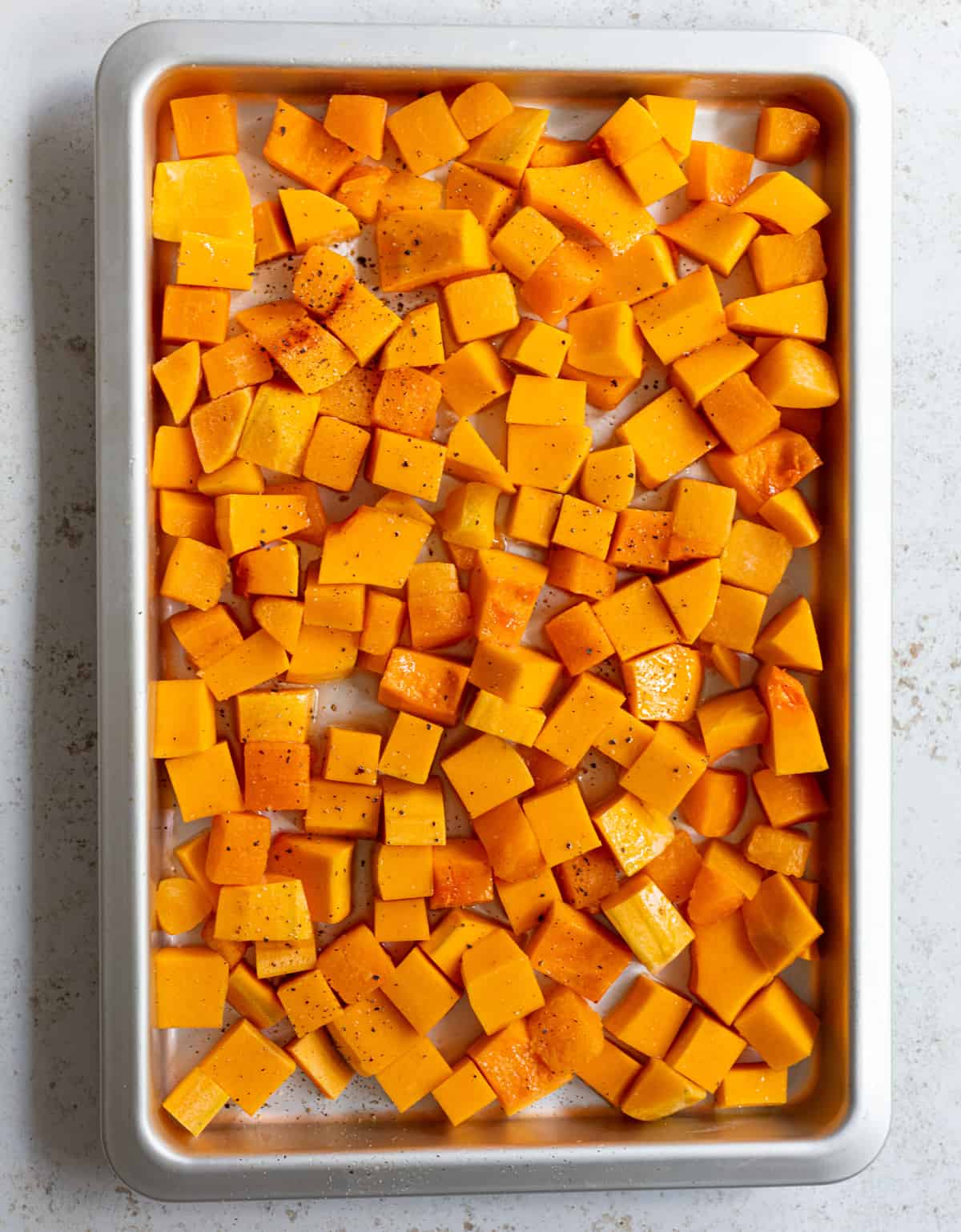 cubed butternut squash on roasting pan