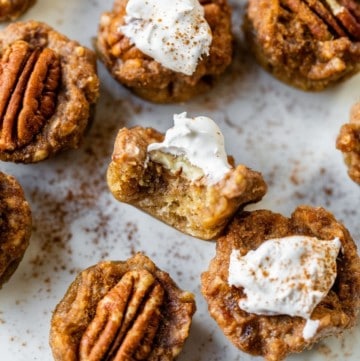 mini pecan pies on a plate with a bite taken out of one
