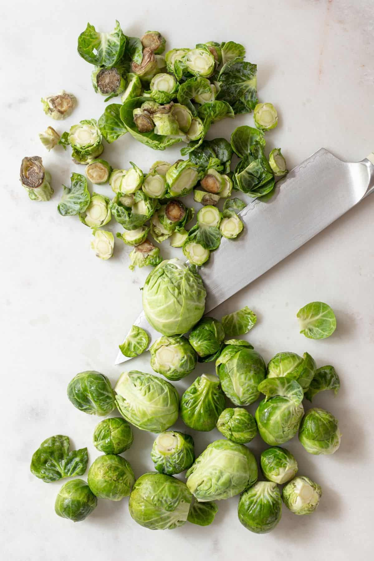 using a knife to shred Brussels sprouts 