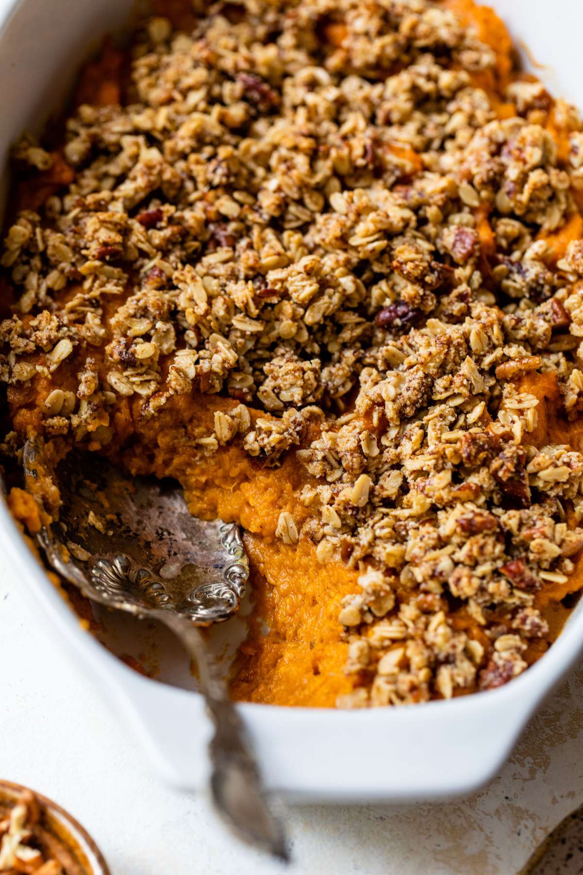 Spooning out a serving of sweet potato casserole.