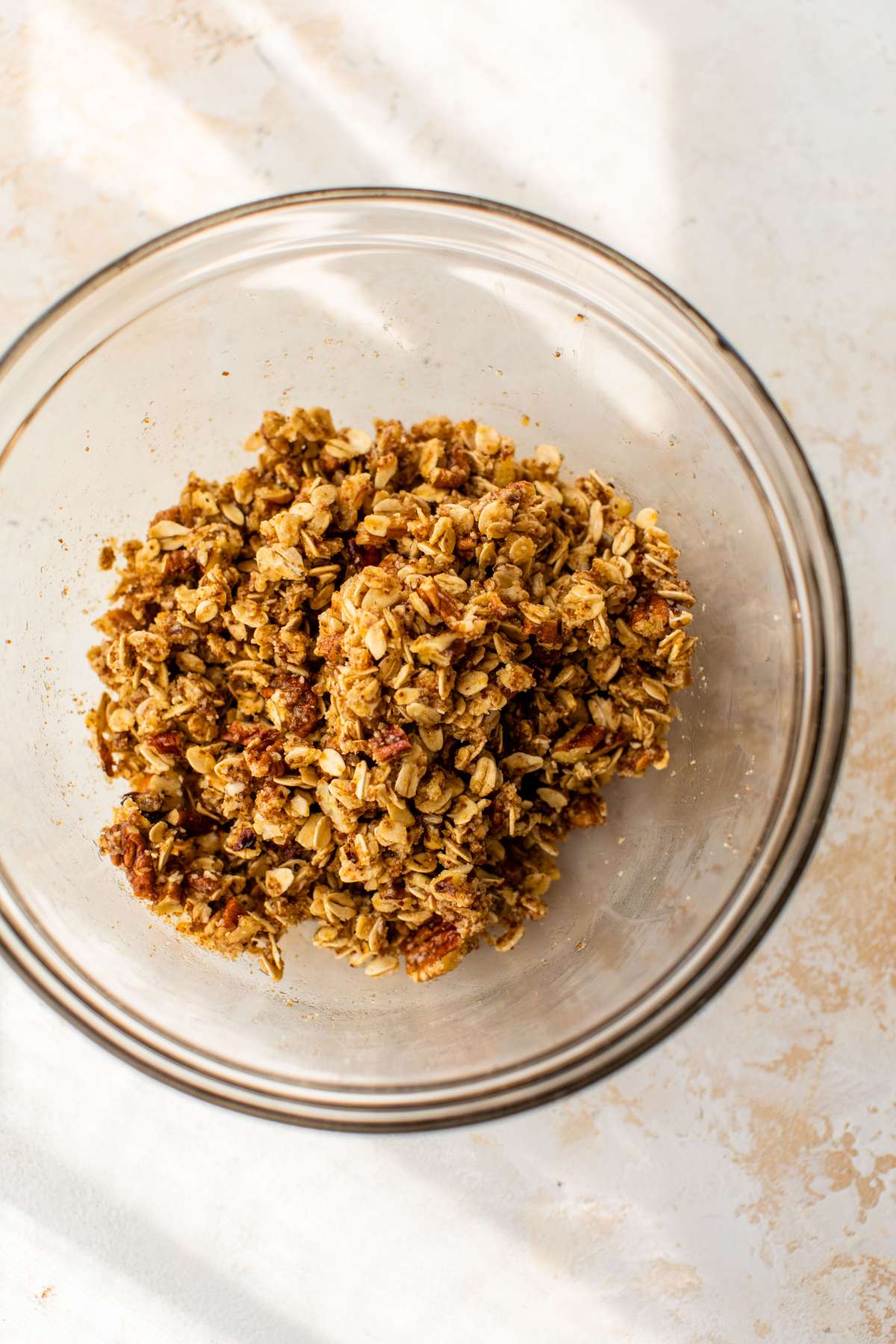 Pecan oat topping in a glass bowl.