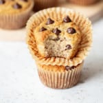almond flour banana muffin stacked with a bite taken our