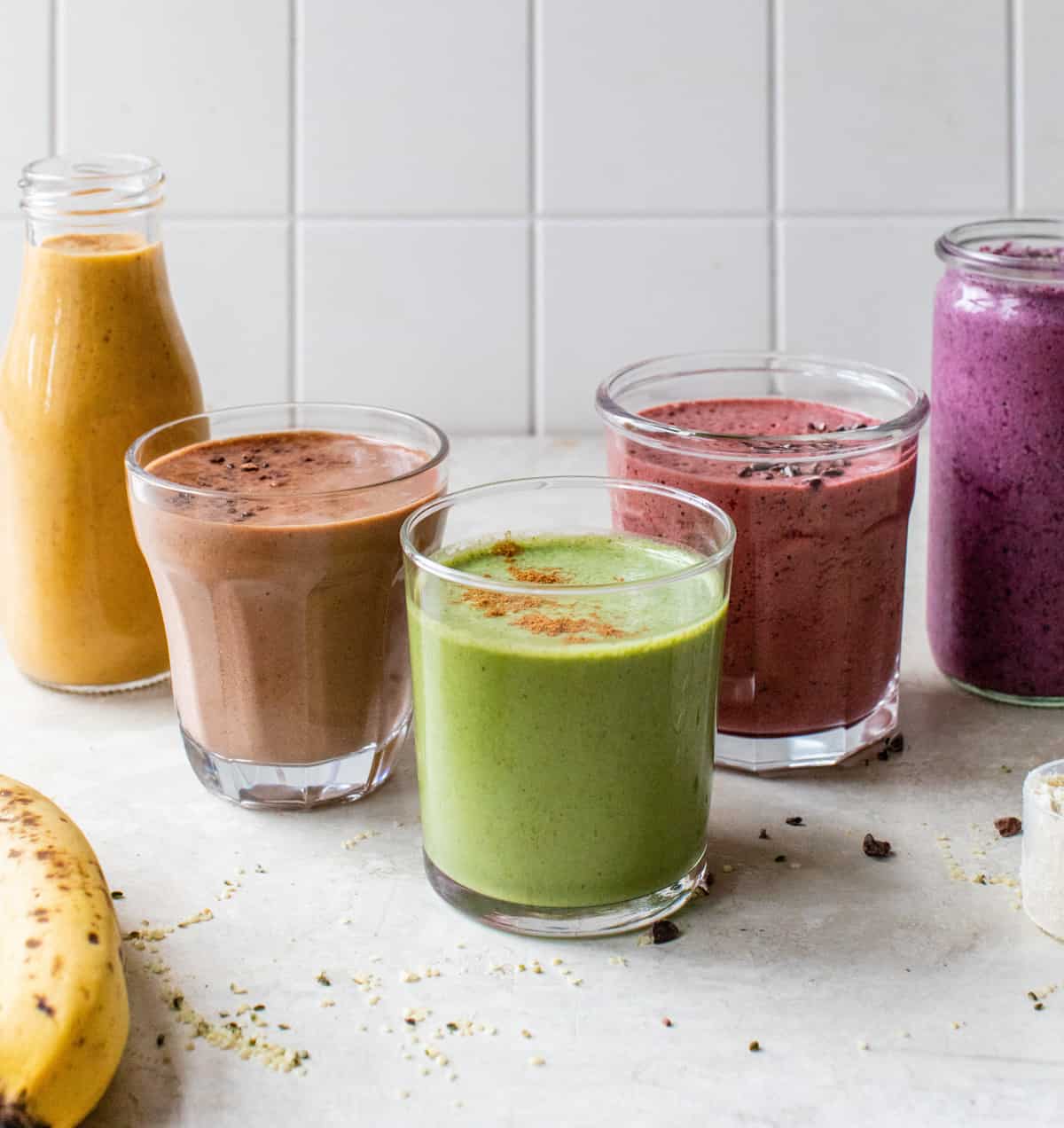 5 healthy morning smoothies on a white counter