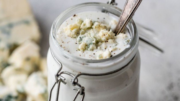 Greek yogurt blue cheese in a small jar with a spoon
