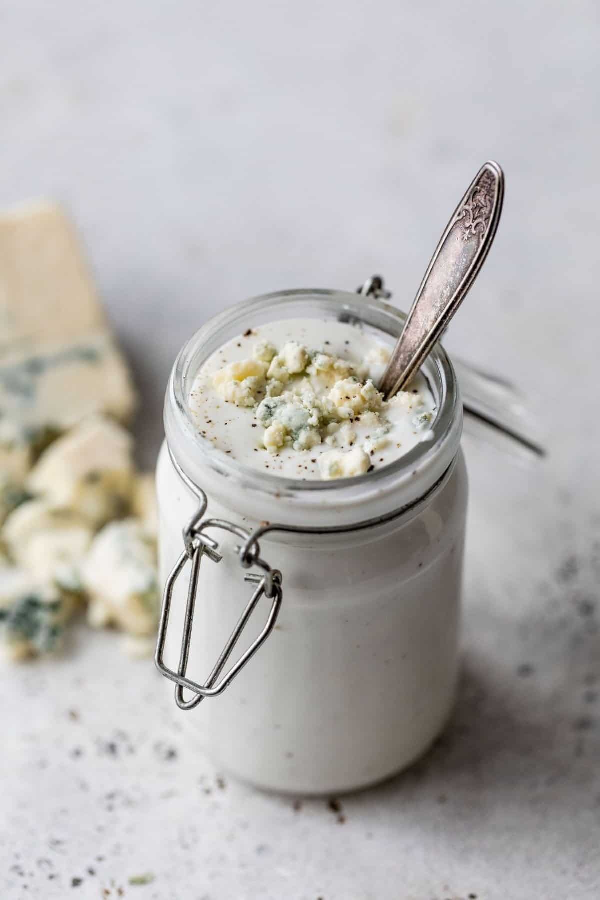 Greek yogurt blue cheese in a small jar with a spoon