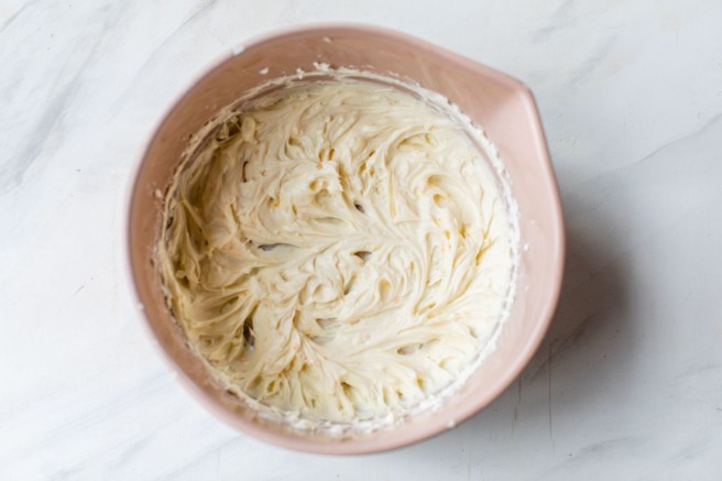 Cream cheese icing mixed in a bowl.