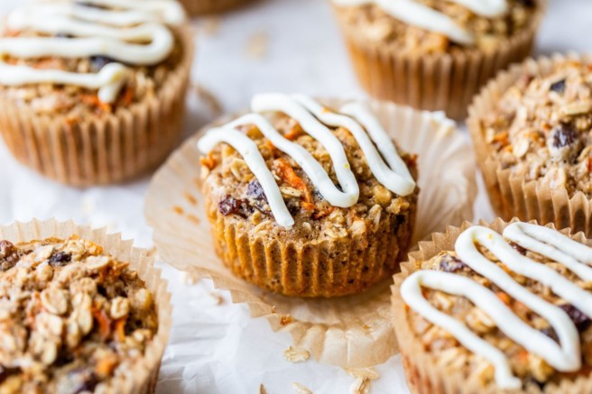 Carrot cake oatmeal muffin topped with cream cheese drizzle.
