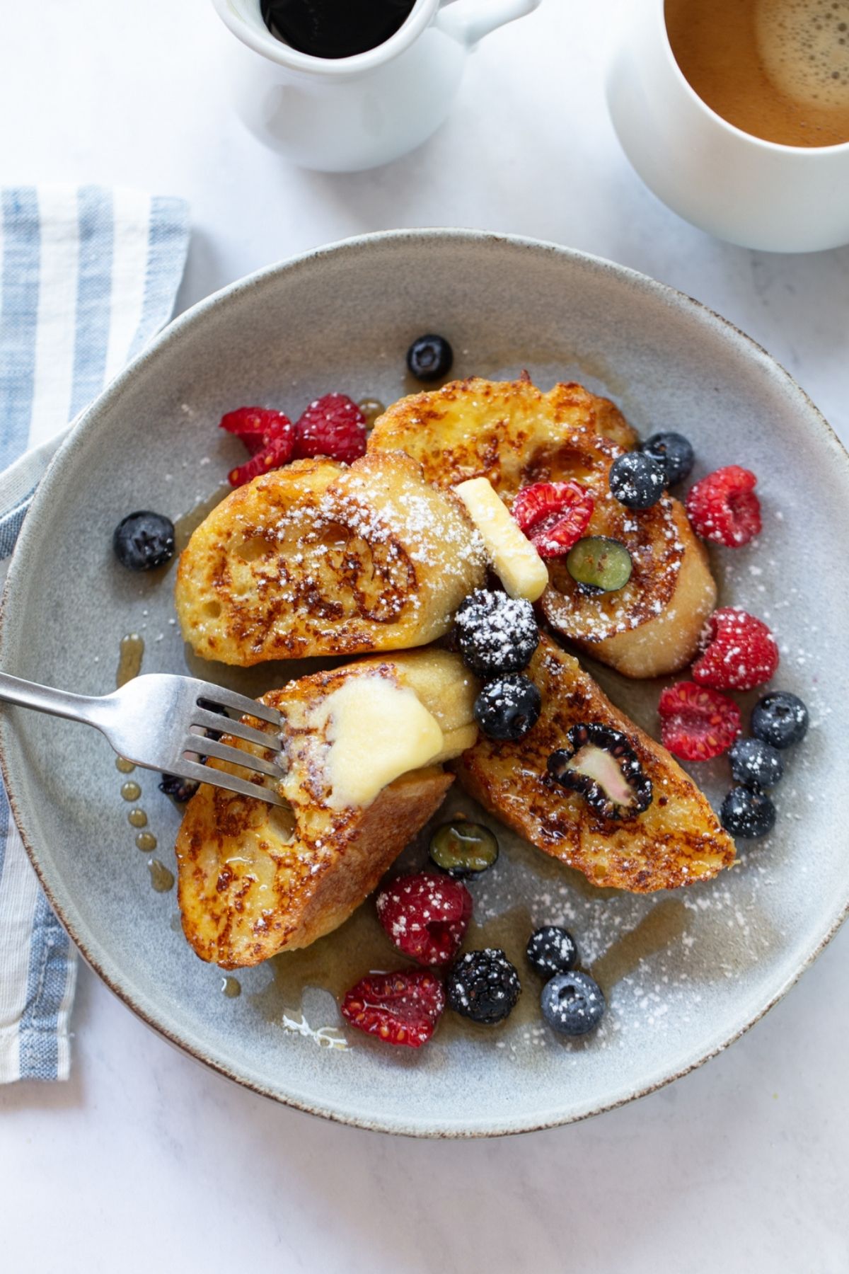 Sourdough French toast topped with berries and butter.
