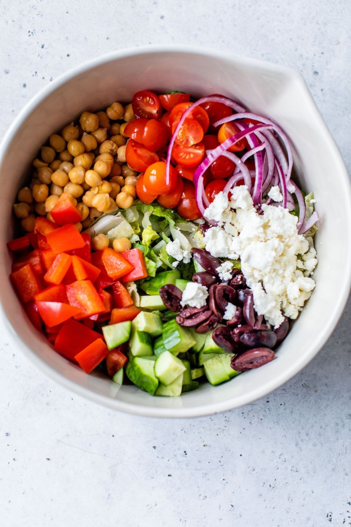 Greek Salad ingredients in a large bowl.