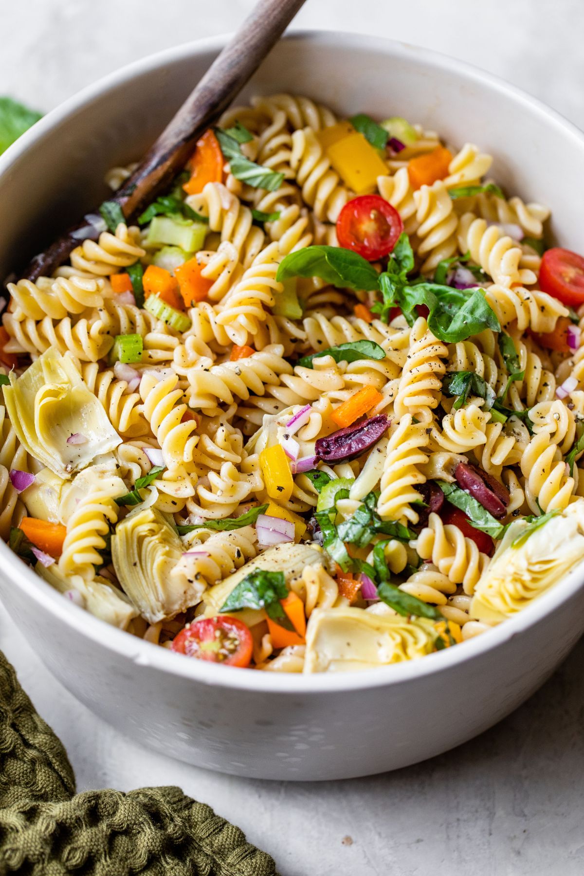 Pasta mixed with veggies in a large bowl.