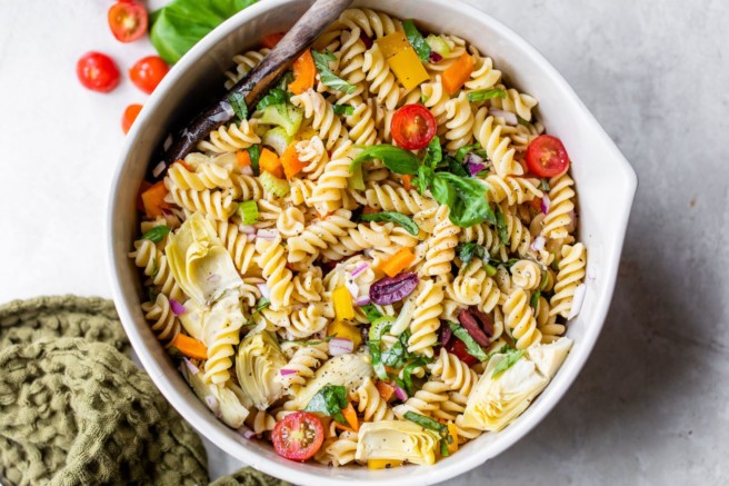 Pasta salad made with tomatoes and basil.