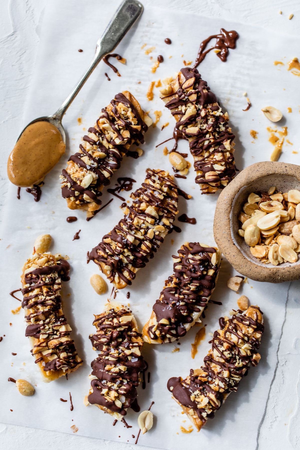 Pieces of banana drizzled with peanut butter and chocolate.