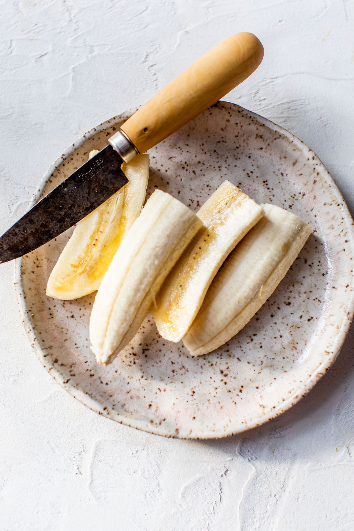 Bananas sliced on a plate.