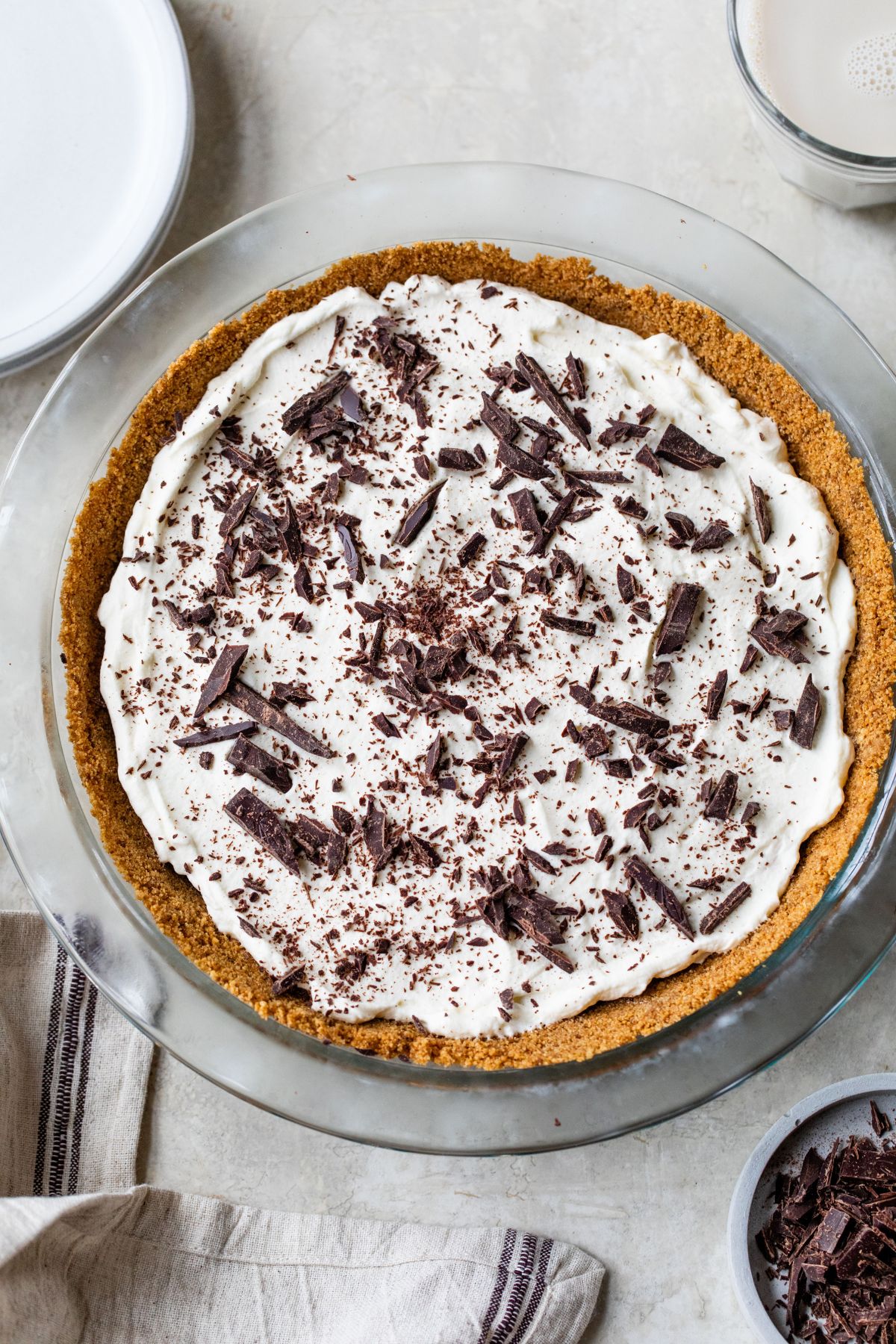 Pie with a graham cracker crust and whipped cream topping.