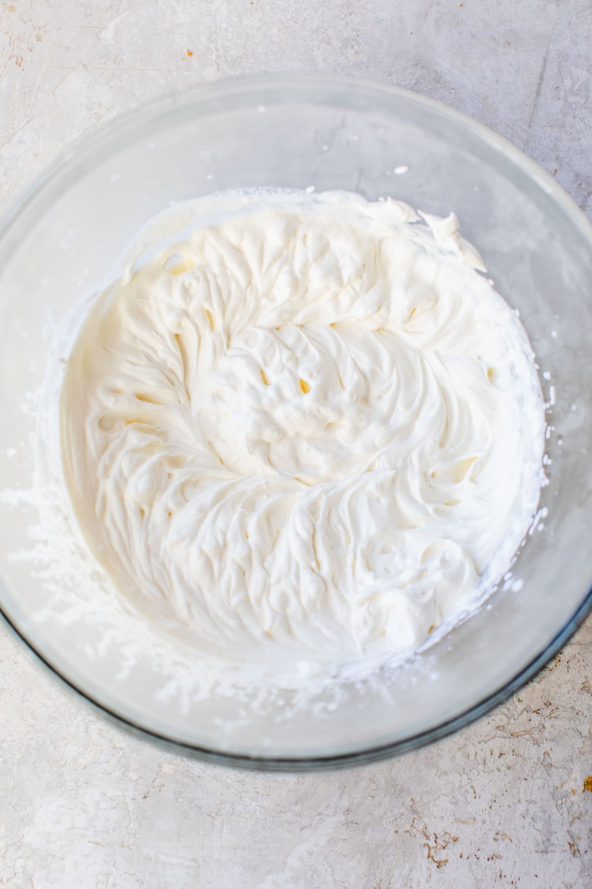 Homemade whipped cream in a large bowl.