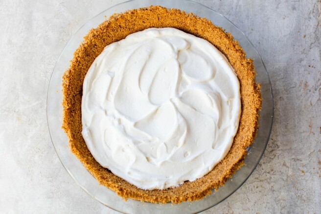 Pie topped with whipped cream.