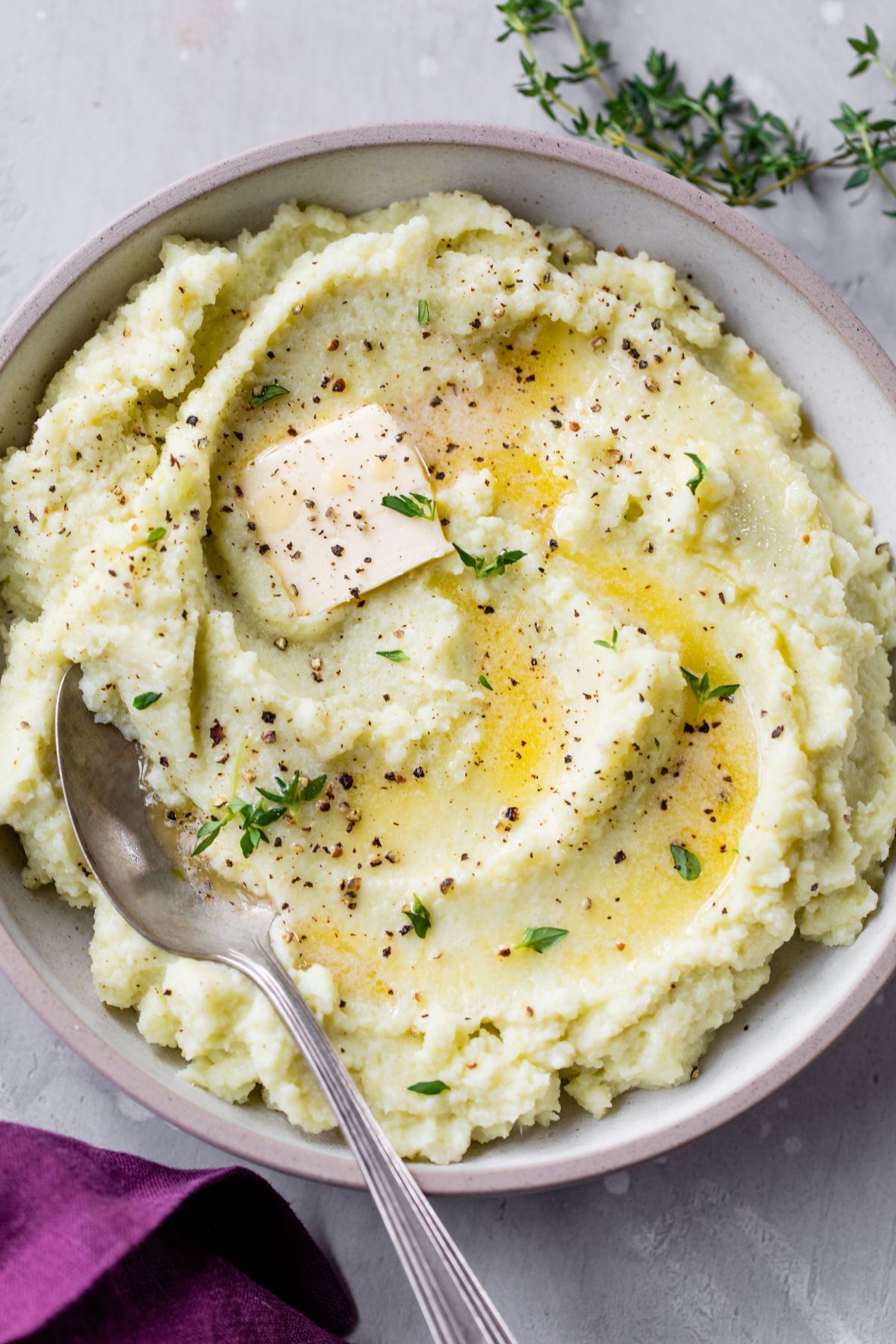 Serving spoon in a bowl filled with cauliflower mash.